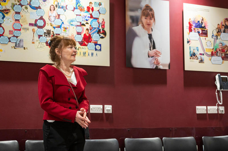  Professor Dame Carol Robinson standing in front of art work by Martin O’Neill at the 5th birthday symposium held by Oxford's Kavli Institute for Nanoscience Discovery.