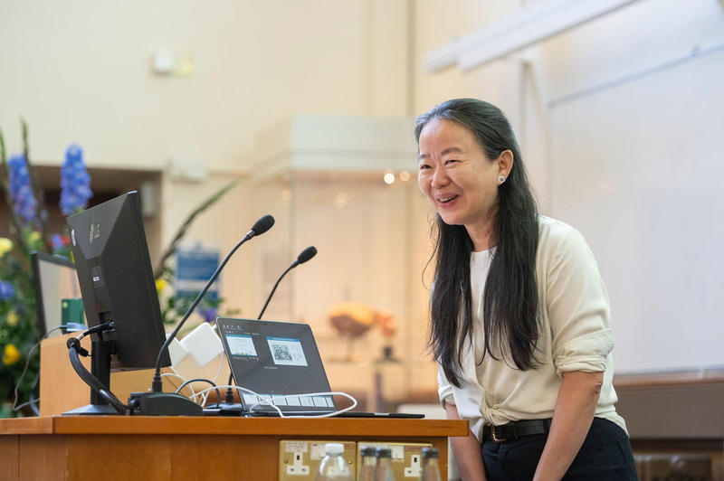 Professor Jue Chen smiling at the podium while delivering her lecture at the Kavli Oxford Lecture Award 2026