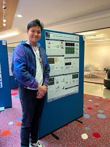 A photograph of Benedict Tanudjojo with his poster.