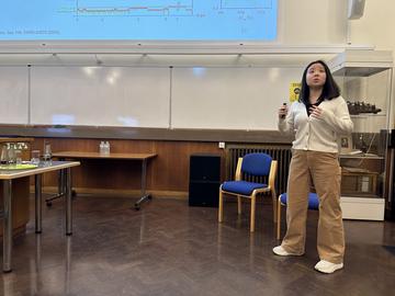 A photo of Yujia Qing presenting.