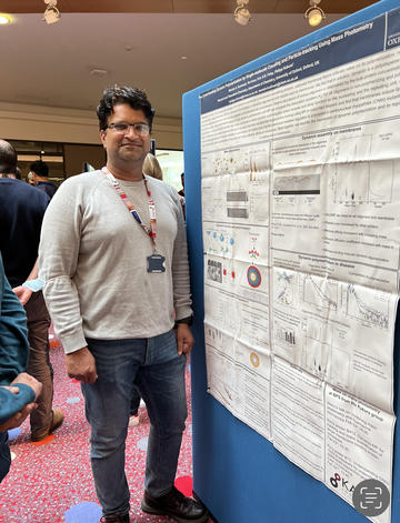A photograph of Manish Singh Kushwah with his poster.