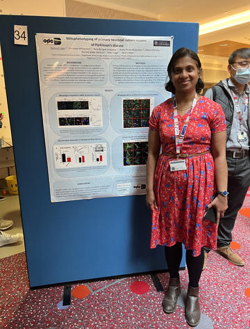 A photograph of Remya Raghavan Nair with her poster.