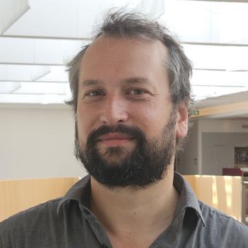A man smiles into the camera