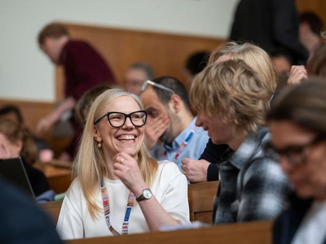  Dr Dominika Gruszka (animated and smiling) and a visiting student in discussion at the 5th birthday symposium held by Oxford's Kavli Institute for Nanoscience Discovery.