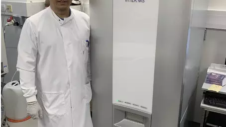 Yohan Arman (DPhil student in the Zitzmann Lab, Department of Biochemistry and Kavli Institute for Nanoscience Discovery) next to the Vitek MALDI-MS system (bioMérieux) in Biochemistry for vaccine authenticity testing
