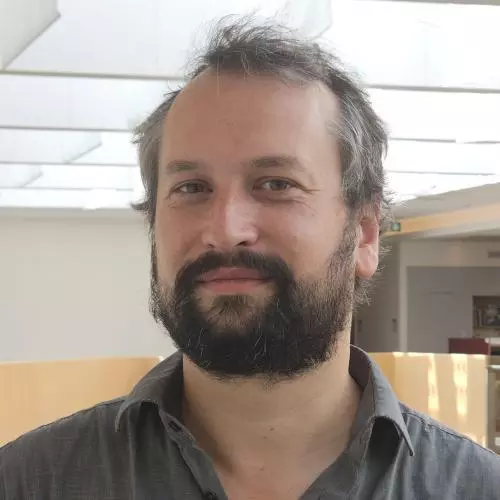 A man smiles into the camera