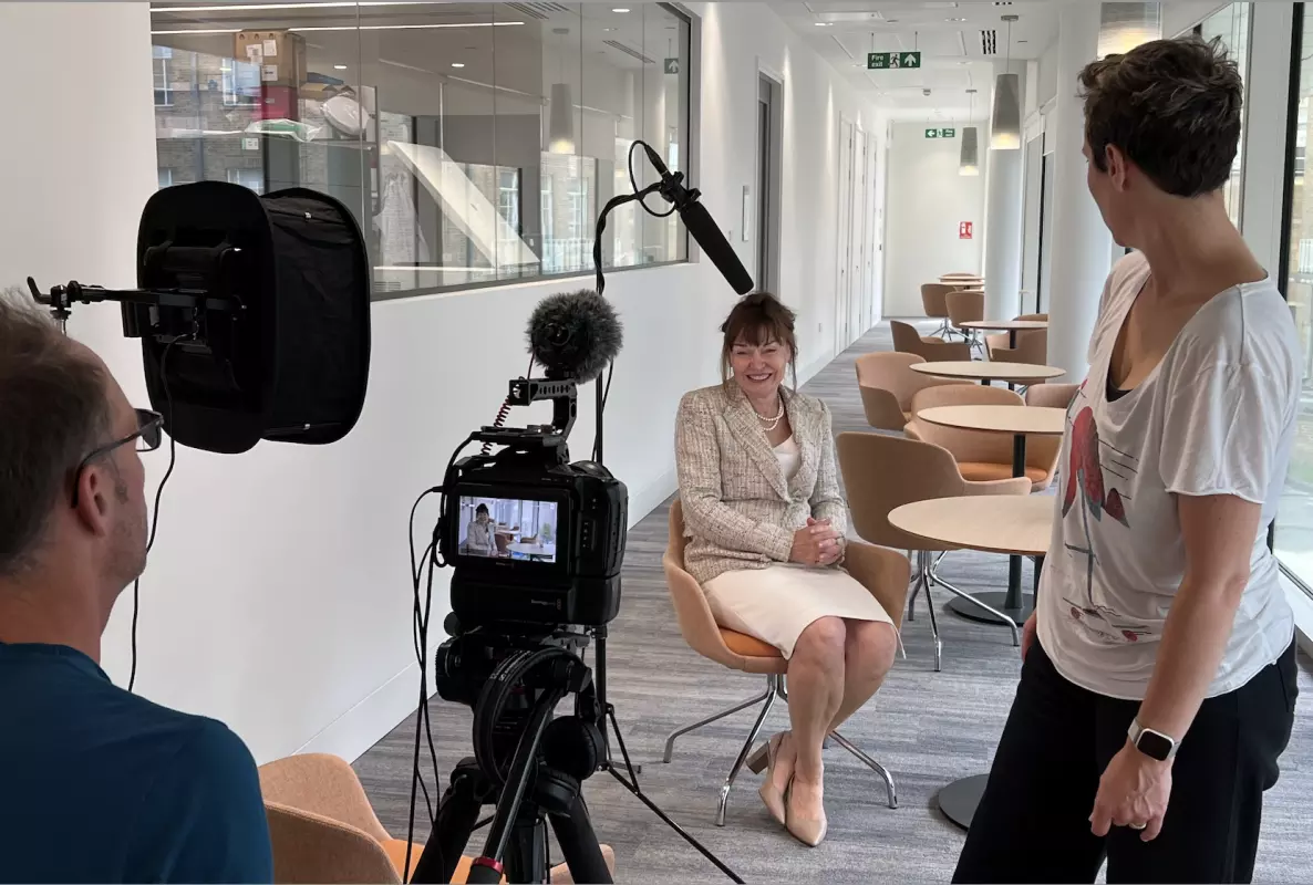 A photograph of Carol Robinson being interviewed.